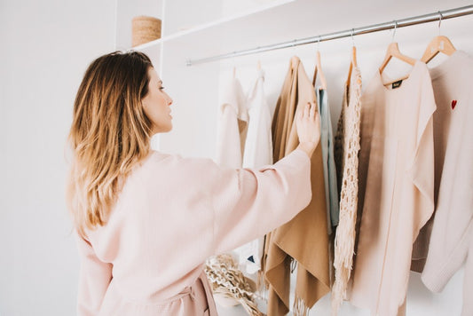Woman choosing from comfortable clothes in her closet