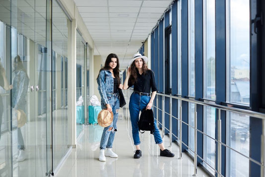 Two stylish women waiting for flight at airport
